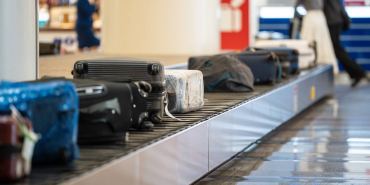 conveyor-belt-filled-with-travelers-bags-and-suitcases-moving-on-automatic-belt-line