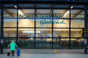 a-female-business-traveller-arrives-with-her-luggage-at-north-terminal-gatwick-airport-london