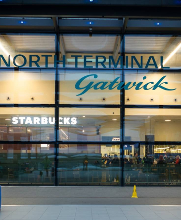 a-female-business-traveller-arrives-with-her-luggage-at-north-terminal-gatwick-airport-london