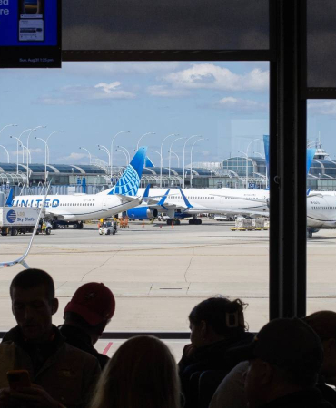 assengers-wait-in-the-boarding-area-for-a-united-airlines-flight-at-chicago-o-hare-international-airport