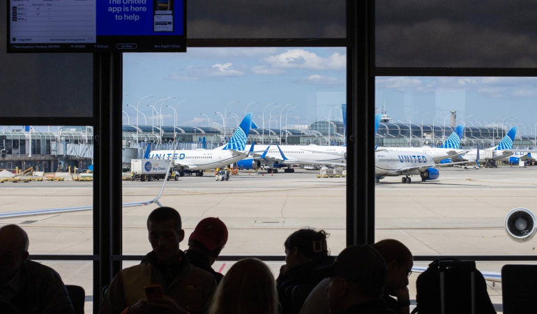 assengers-wait-in-the-boarding-area-for-a-united-airlines-flight-at-chicago-o-hare-international-airport