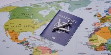 blue-passport-and-model-airplane-placed-on-a-world-2026-07-17-21-04-06-utc-1