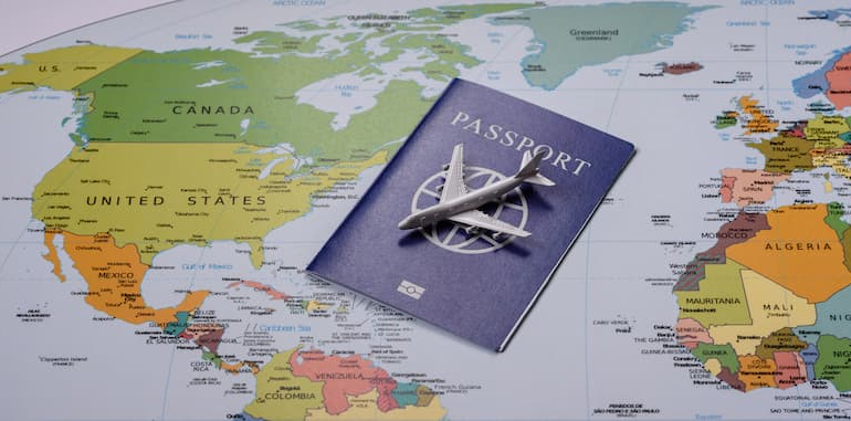 blue-passport-and-model-airplane-placed-on-a-world-2026-07-17-21-04-06-utc-1