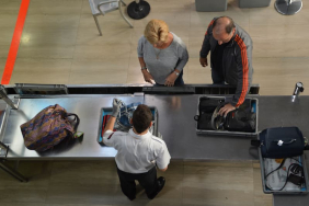 directli-above-shot-of-officer-checking-baggage-on-2026-01-08-22-06-23-utc-1