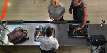 directli-above-shot-of-officer-checking-baggage-on-2026-01-08-22-06-23-utc-1