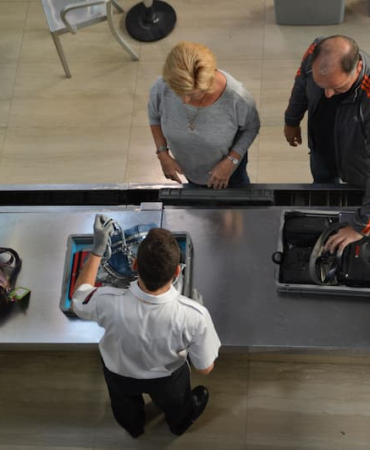 directli-above-shot-of-officer-checking-baggage-on-2026-01-08-22-06-23-utc-1