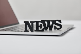 selective-focus-of-black-news-lettering-near-lapto-2024-11-19-12-28-50-utc-1