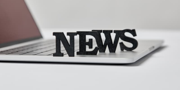 selective-focus-of-black-news-lettering-near-lapto-2024-11-19-12-28-50-utc-1