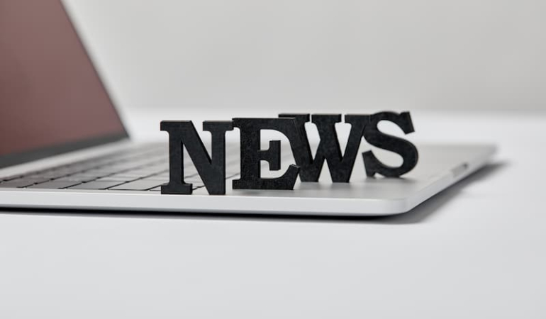 selective-focus-of-black-news-lettering-near-lapto-2024-11-19-12-28-50-utc-1