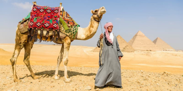 three-pyramids-and-tourist-guide-with-camel-2025-04-04-17-00-35-utc-1