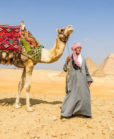 three-pyramids-and-tourist-guide-with-camel-2025-04-04-17-00-35-utc-1
