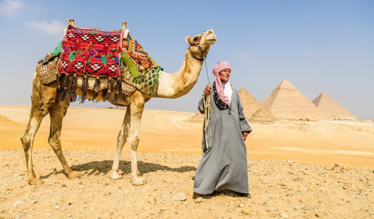 three-pyramids-and-tourist-guide-with-camel-2025-04-04-17-00-35-utc-1